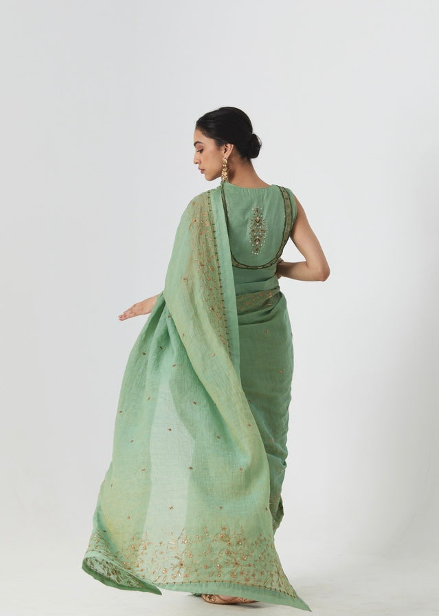Krisha - A sage green tissue chanderi hand embroidered saree with tonal embroidered blouse