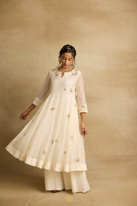 Asin - An ivroy white mul chanderi anarkali with sharara paired with a kota silk dupatta, handcrafted ari and zardosi embroidery