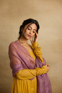 Meher – Golden yellow tissue chanderi Anarkali sharara set paired with mauve kota silk dupatta, handcrafted ari and zardozi embroidery