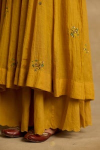 Meher – Golden yellow tissue chanderi Anarkali sharara set paired with mauve kota silk dupatta, handcrafted ari and zardozi embroidery