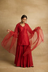 Tiya – A rust red chanderi silk sharara set, organza dupatta, handcrafted ari zardozi work