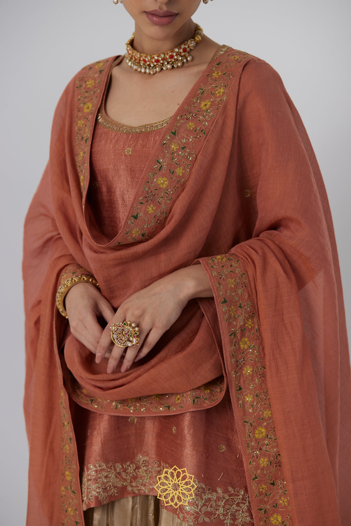 Tanira- A rust peach hand embroidered raw silk kurta with soft gold banarasi silk tissue sharara