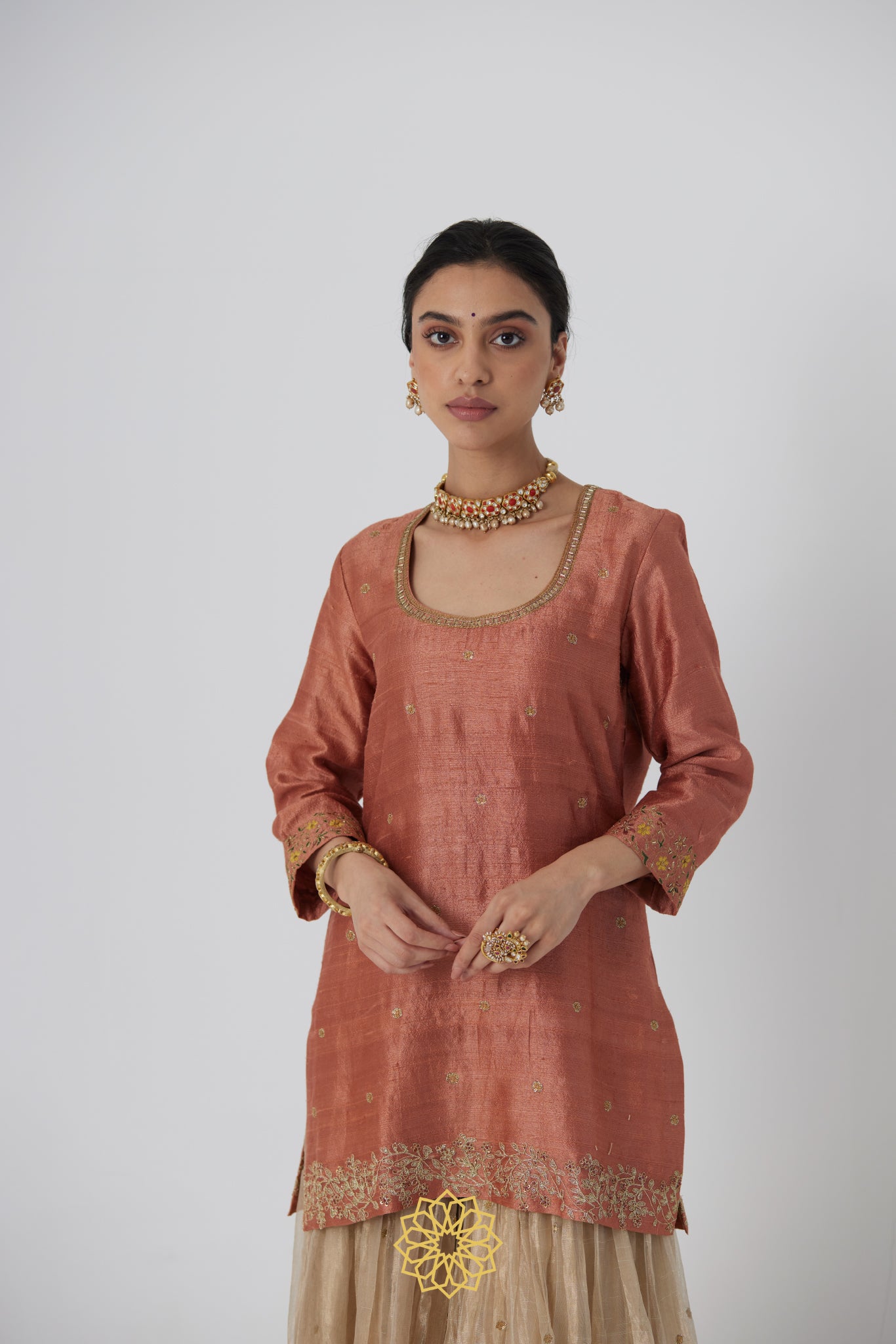 Tanira- A rust peach hand embroidered raw silk kurta with soft gold banarasi silk tissue sharara