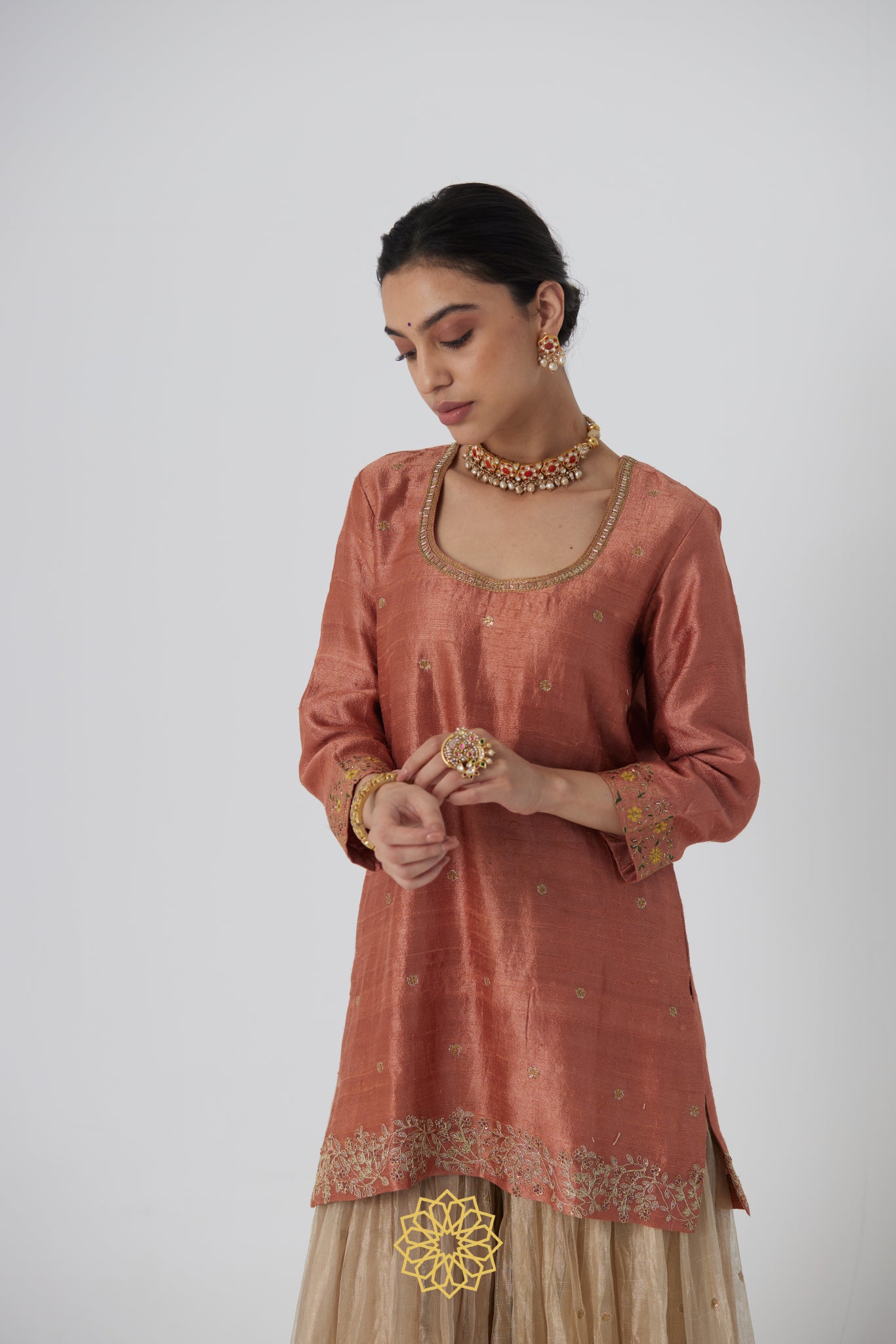 Tanira- A rust peach hand embroidered raw silk kurta with soft gold banarasi silk tissue sharara