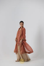 Load image into Gallery viewer, Tanira- A rust peach hand embroidered raw silk kurta with soft gold banarasi silk tissue sharara
